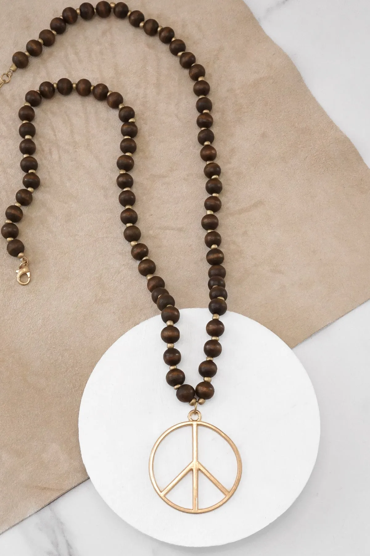 Long Wood Bead Necklace with golden peace sign pendant - Brown