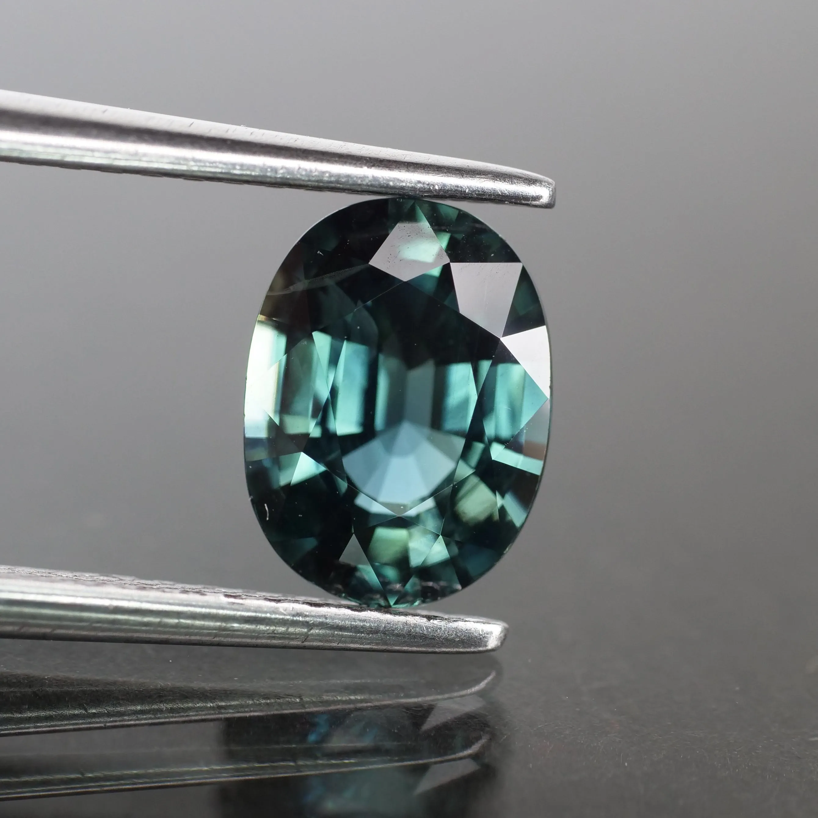 Sapphire | natural, teal (bluish green color changing), oval cut 8x6 mm, IF, 1.68 ct, Thailand